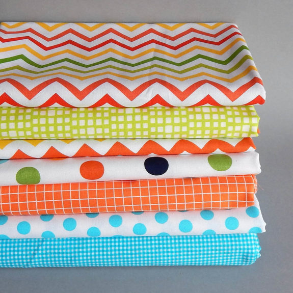 stack of brightly colored calico fabric