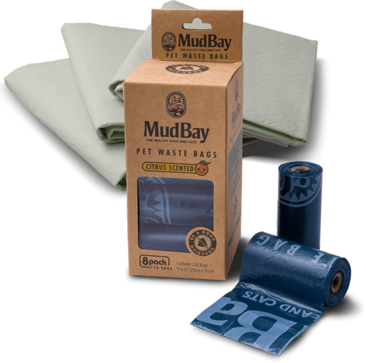 rolls of poop bags and a stack of puppy pads