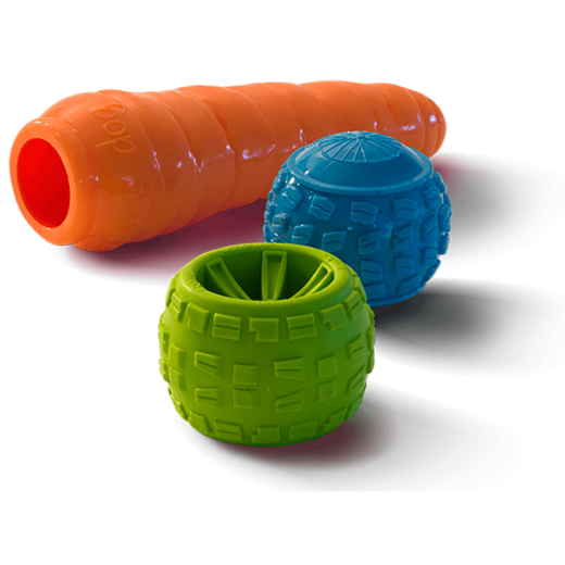 A carrot dog toy, a small green tire dog toy, and a blue ball dog toy